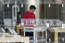 Một nhân viên Apple Store chuẩn bị khai trương cơ sở kinh doanh tại Bắc Kinh hôm 16/12/2023. (Ảnh: Wang Zhao/AFP qua Getty Images)