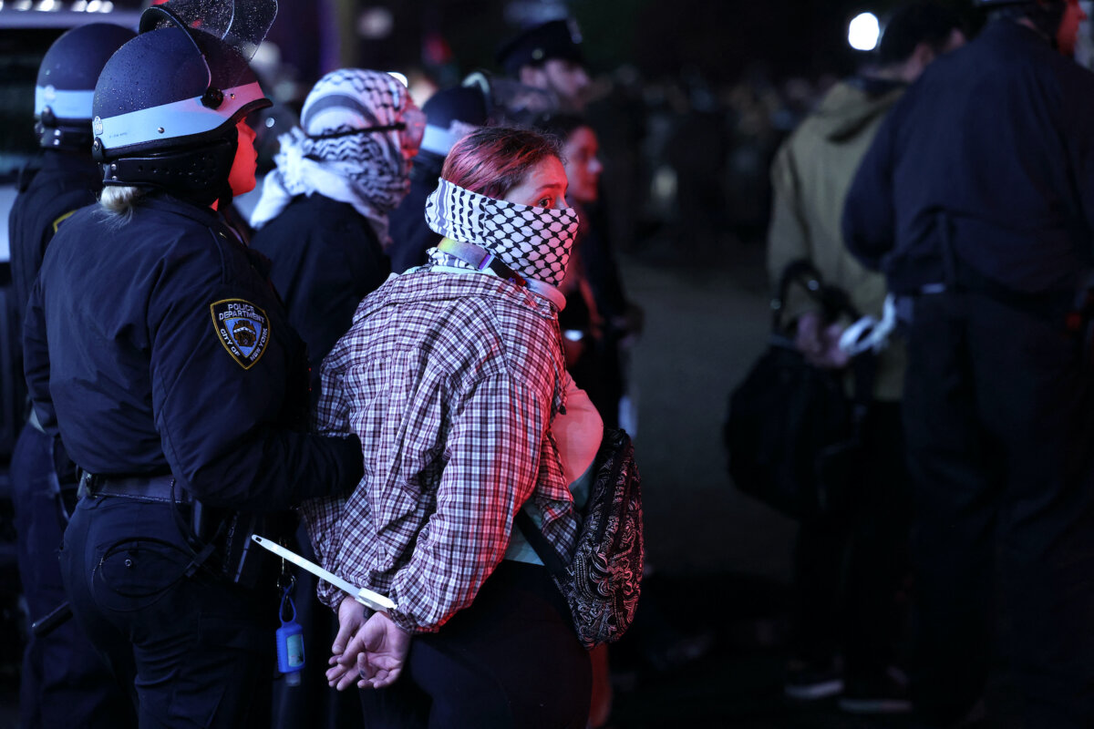 Các cảnh sát NYPD bắt giữ sinh viên khi họ lấy lại một tòa nhà bị những sinh viên biểu tình ủng hộ Palestine lập rào chặn tại Đại học Columbia ở thành phố New York, hôm 30/04/2024. (Ảnh: Charly Triballeau/AFP/Getty Images)