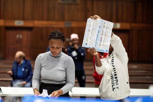 Một viên chức của Ủy ban Bầu cử Nam Phi cầm một lá phiếu đã được đánh dấu trong quá trình kiểm đếm phiếu tại điểm bỏ phiếu trong trường Norwood ở Durban, Nam Phi, trong cuộc tổng tuyển cử của Nam Phi hôm 29/05/2024. (Ảnh: Gianluigi Guercia/AFP qua Getty Images)