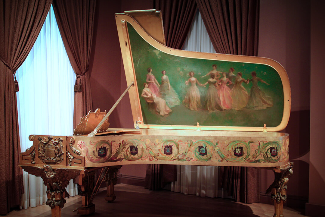 Cây dương cầm đầu tiên của Tòa Bạch Ốc do Hãng Steinway & Sons sản xuất, có bức tranh “America Receiving the Nine Muses” (Mỹ Quốc Chào Đón Chín Nữ Thần Muse) của họa sỹ Thomas Wilmer Dewing bên trong nắp đàn. (Ảnh: Được Mr.TinMD/CC BY-ND 2.0 chỉnh sửa màu sắc)