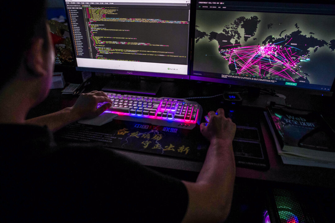 Một thành viên của nhóm tin tặc Red Hacker Alliance từ chối cung cấp tên thật đang sử dụng một trang web theo dõi các cuộc tấn công mạng toàn cầu trên máy điện toán của mình tại văn phòng ở Đông Quản, tỉnh Quảng Đông, Trung Quốc, vào ngày 04/08/2020. (Ảnh: Nicolas Asfouri/AFP qua Getty Images)